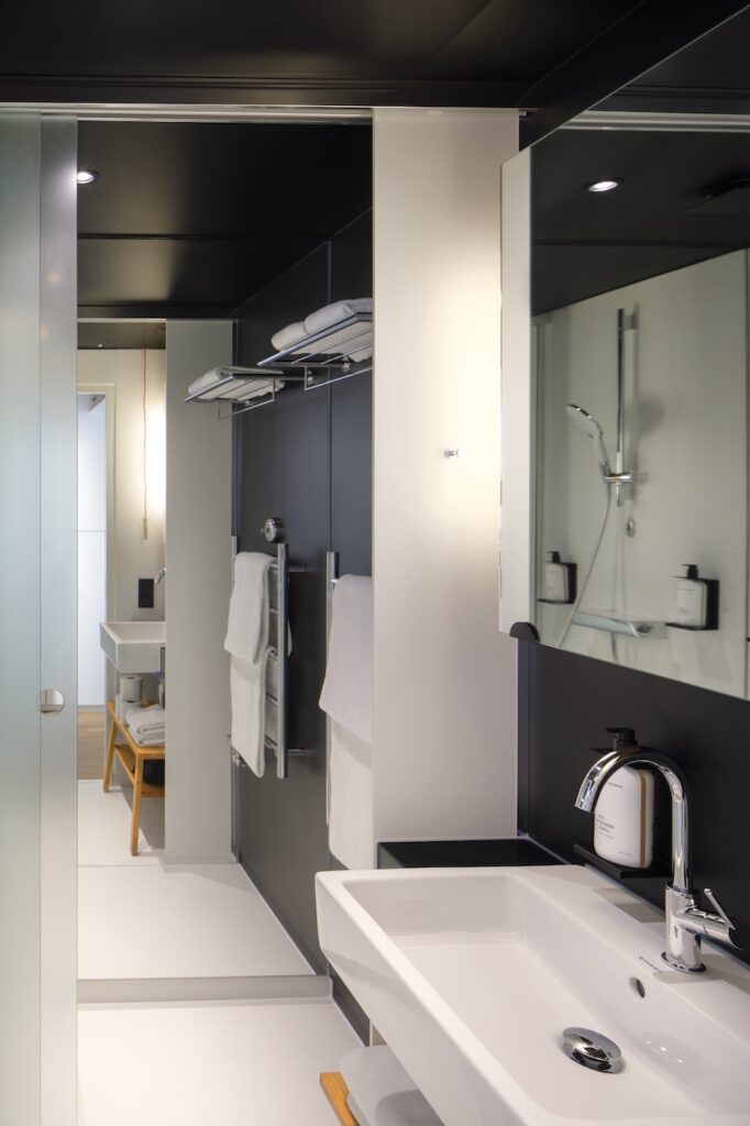 Zoku Paris bathroom with sink, storage, and mirrored shower