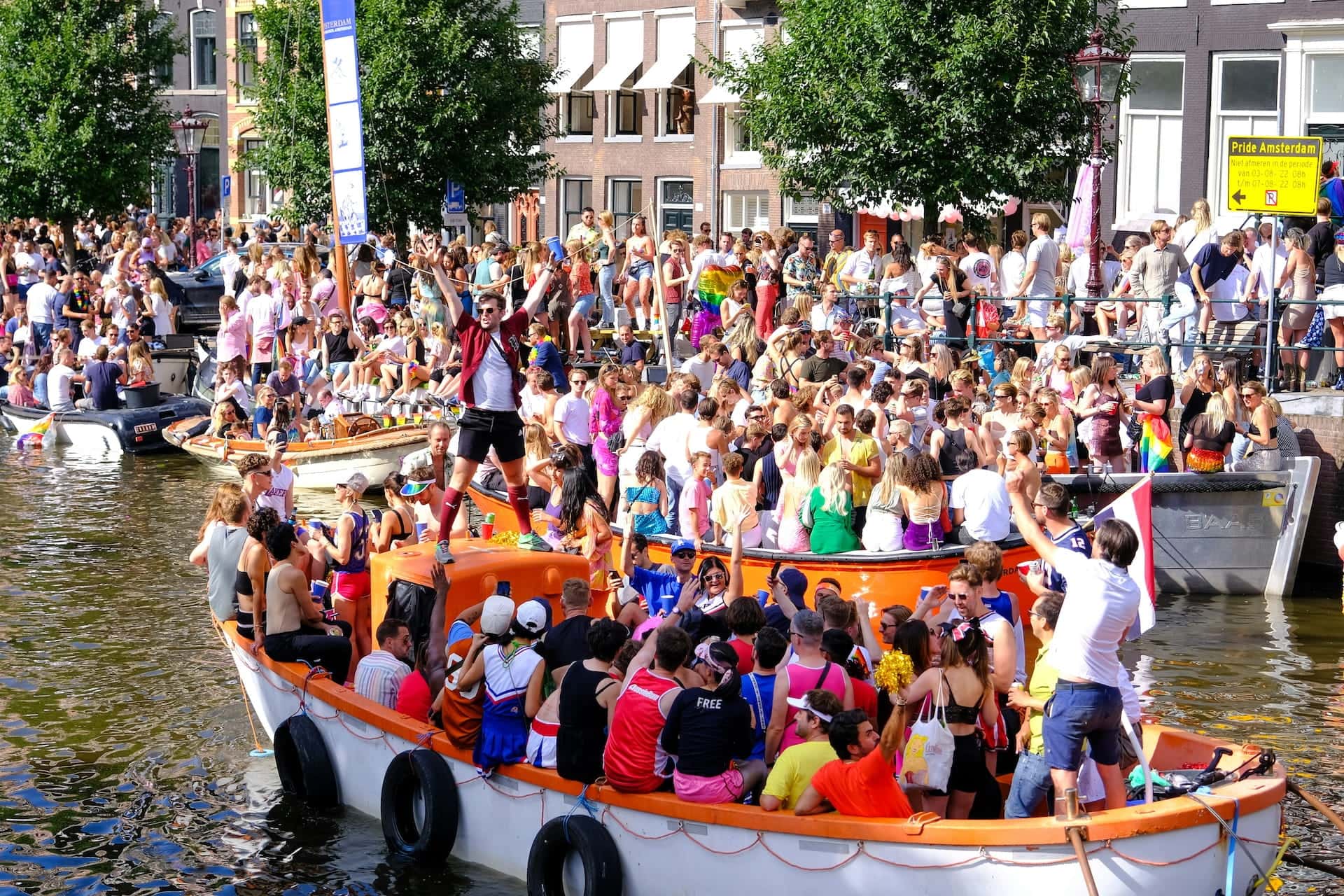 People on boats during Amsterdam Pride.